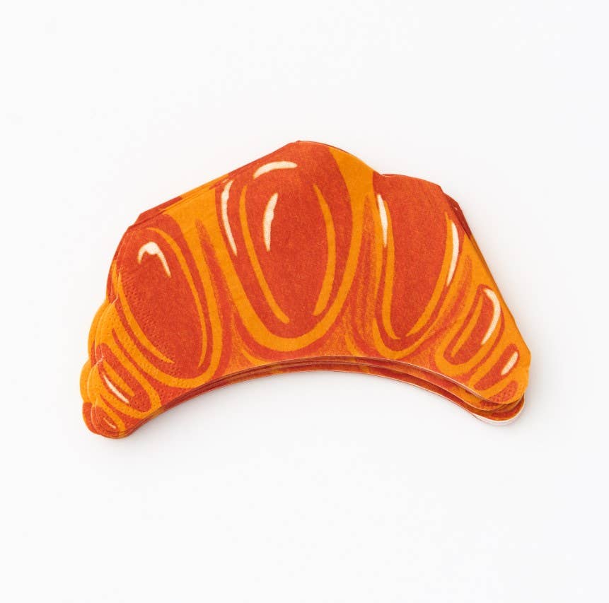 Decorative paper napkin shaped like a croissant with orange and brown colors.