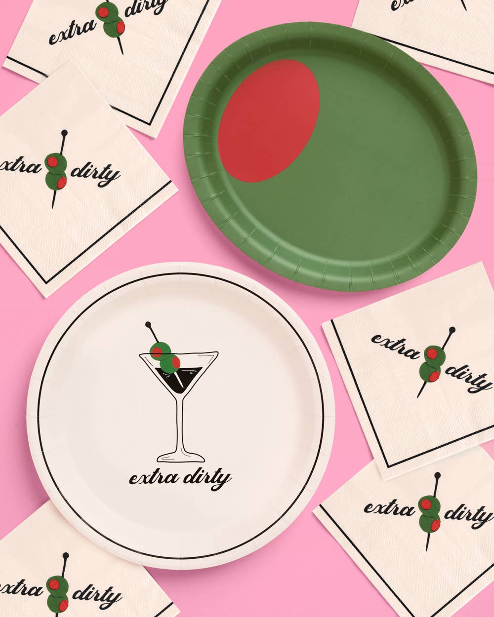 Paper plates with 'extra dirty' martini design on a pink background