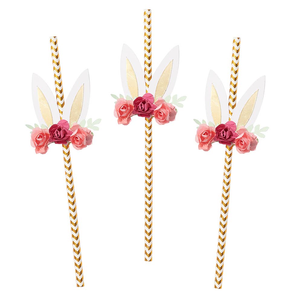 A set of three paper straws adorned with floral bunny ears in white and gold, with pink and green flowers.