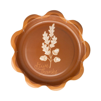 Brown decorative plate with 'Give Thanks' text and leaf design with scalloped edge trim.