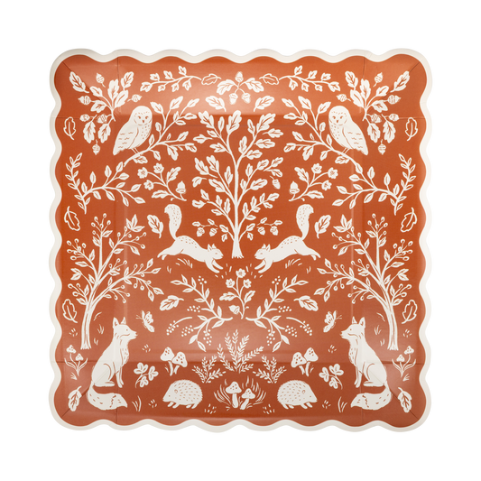 Decorative square rust-colored paper plate with white forest animals and plants pattern.