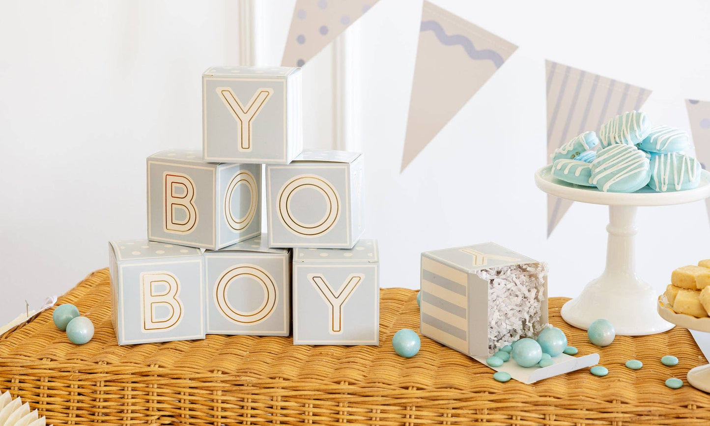 Decorative baby block party favors spelling 'BOY' on a table with baby shower decorations.