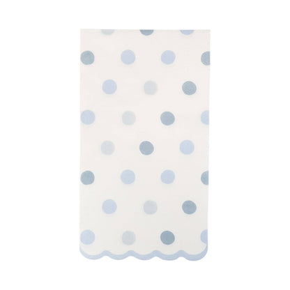 White guest towel napkin with blue polka dots on a white background