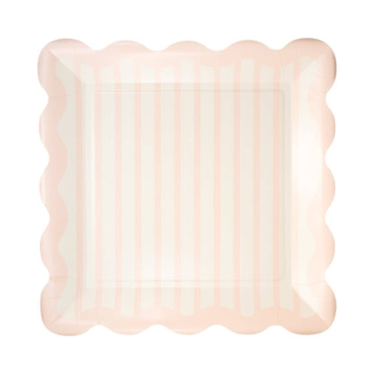 Decorative plate with scalloped edge and pink and white striped pattern on a white background.
