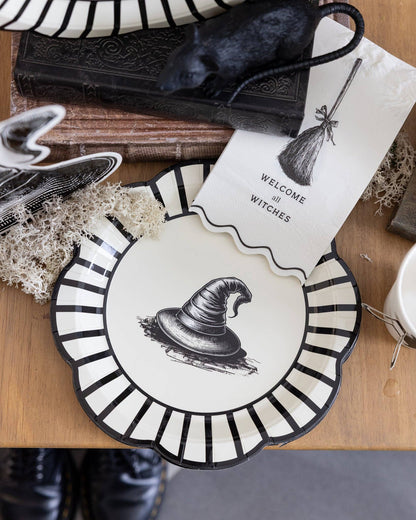 Halloween-themed plate with black and white design on a wooden surface