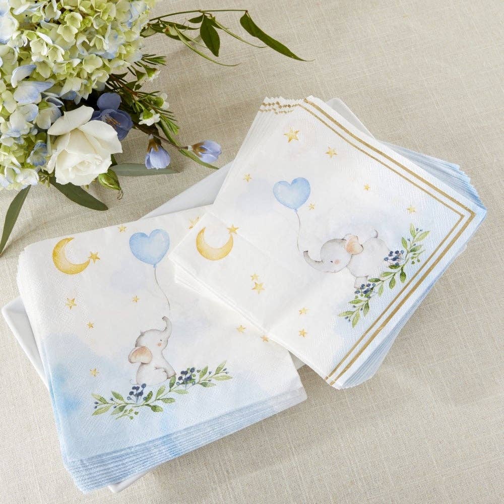 Set of baby-themed paper napkins with floral and animal designs on a beige surface with flowers.