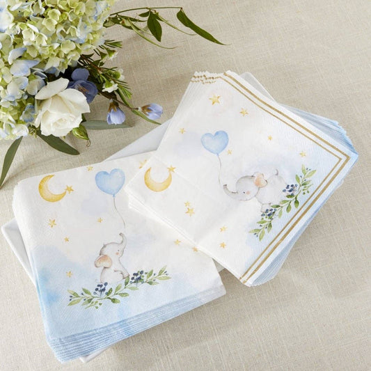 Set of baby-themed paper napkins with floral and animal designs on a beige surface with flowers.