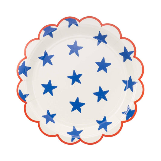 Decorative white plate with blue stars and a red scalloped trim on a white background