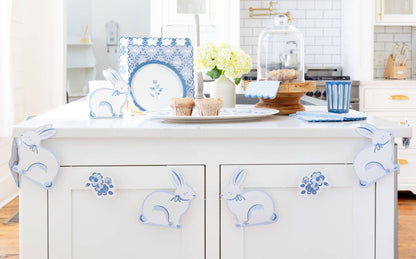 Kitchen island with blue Easter decorative elements and a view of a kitchen.