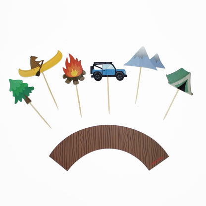 A set of cupcake toppers in various shapes including a bear, a campfire, a car, and mountains, along with cupcake wrappers that mimic a wood grain pattern.