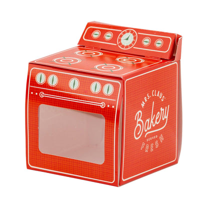 Red treat box designed to look like a vintage stove with 'Mrs. Claus' Bakery' branding and clear window front to see inside box.