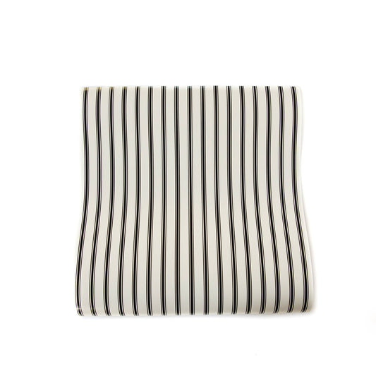 Striped cream colored paper table runner with black stripes on a white background.