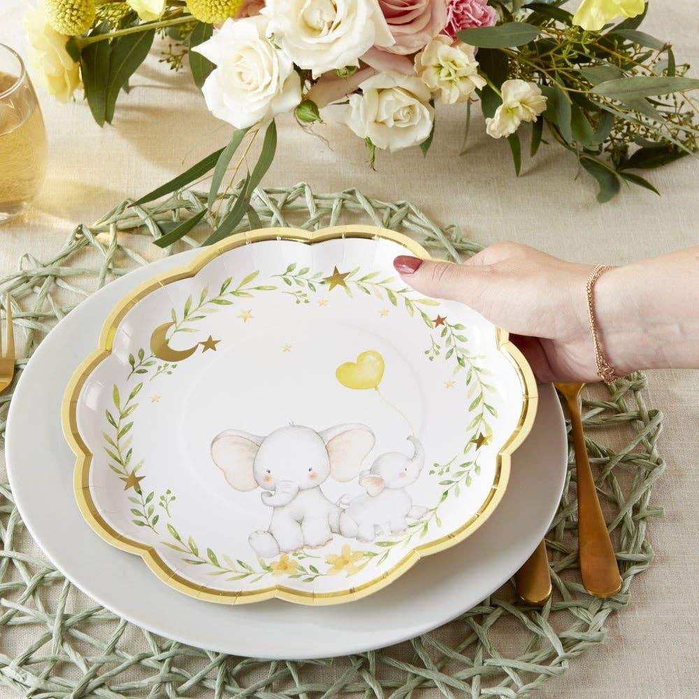 Decorative gender neutral baby shower plate with elephant design on a table setting with flowers.