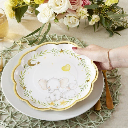 Decorative gender neutral baby shower plate with elephant design on a table setting with flowers.