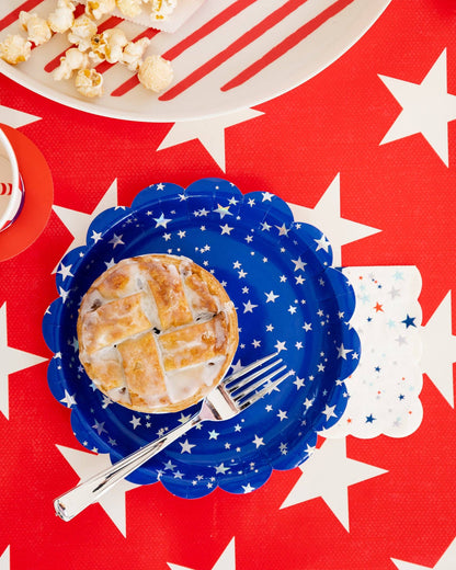 Pie on a blue paper plate with stars on a red background