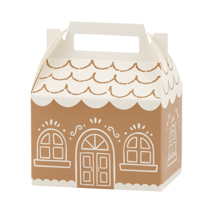 A gingerbread house shaped party favor box with a white handle, featuring brown sides and a white scalloped roof and trim with white window and door illustrations.