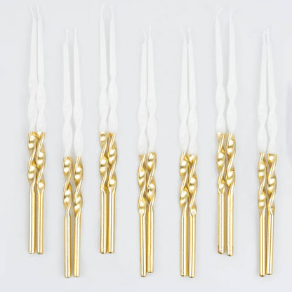 Gold dipped spiral birthday candles on a white background