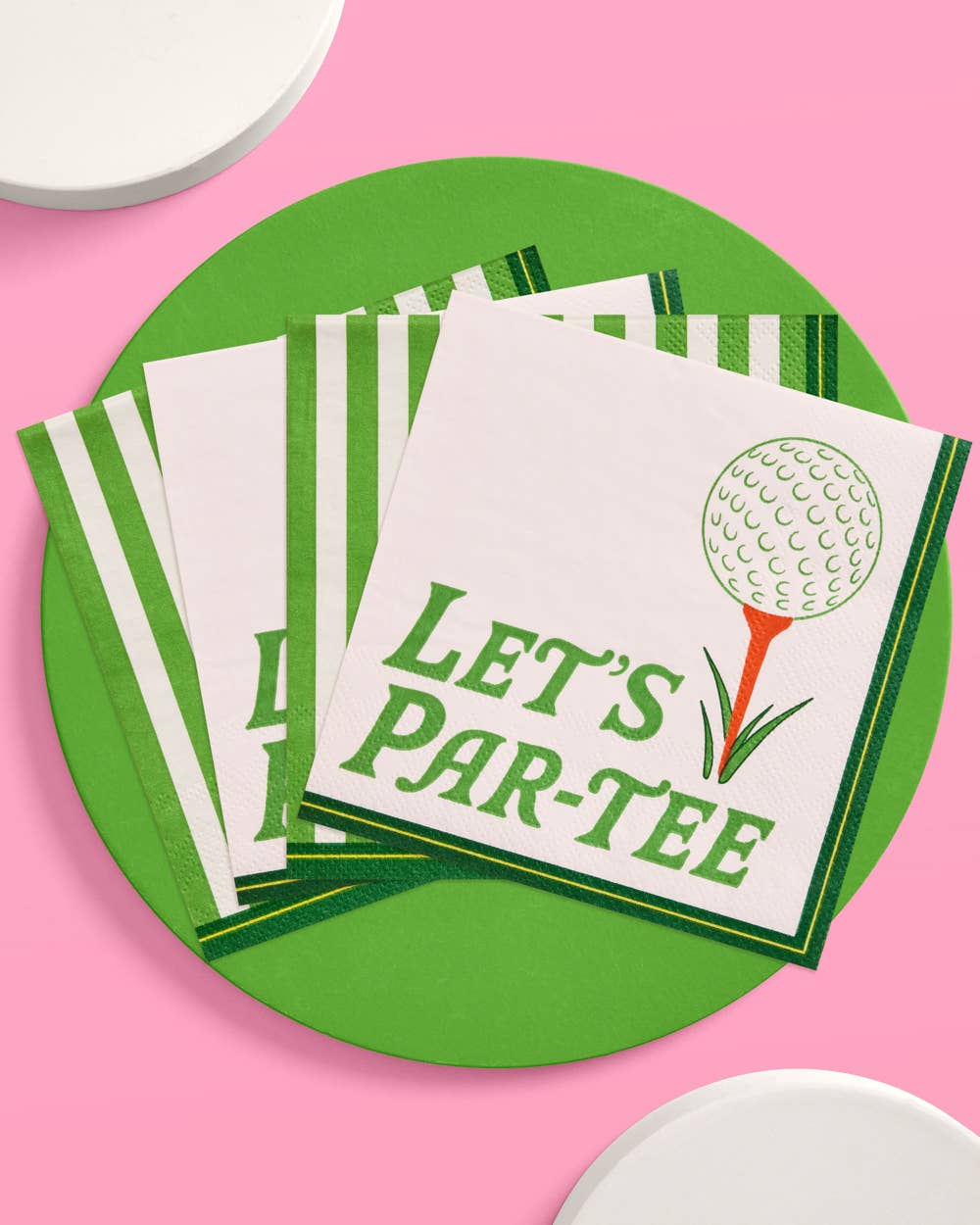 Set of napkins with 'Let's Par-Tee' design on a green plate against a pink background