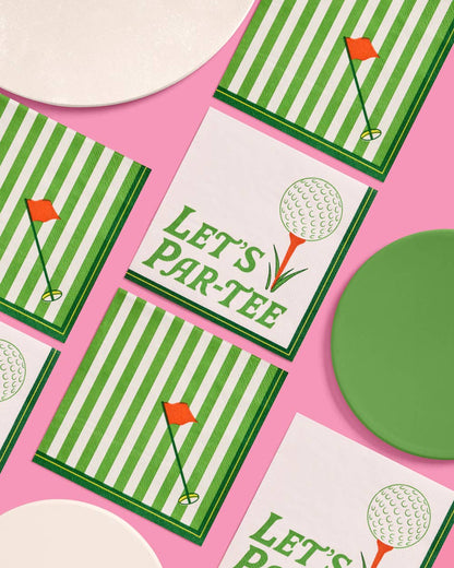 Golf-themed party cocktail napkins with green stripes and golf ball designs on a pink background.