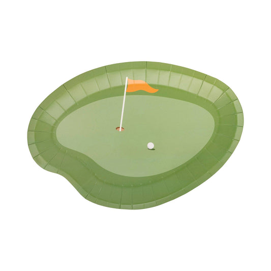 Paper plate shaped like a golf green with a hole, flag, and ball on a white background.