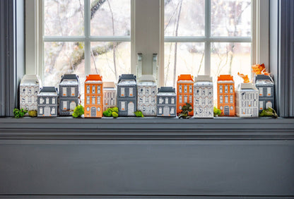 Halloween Village House Treat Boxes on a windowsill with a rainy landscape outside