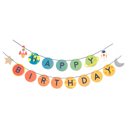 A colorful birthday banner with a space theme, featuring letters spelling out 'HAPPY BIRTHDAY', stars, and moon decorations, all in a flat lay arrangement.