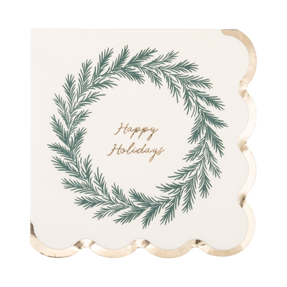 A square paper napkin with scalloped edges, featuring a green pine wreath illustration and the words 'Happy Holidays' in gold script on a warm off-white background.