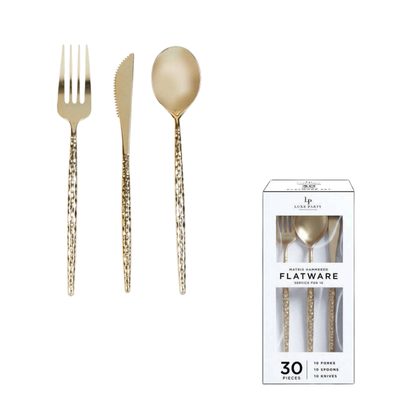 Gold-colored flatware set with textured handles, including a fork, knife, and spoon, shown next to its white retail packaging box on a solid white background.