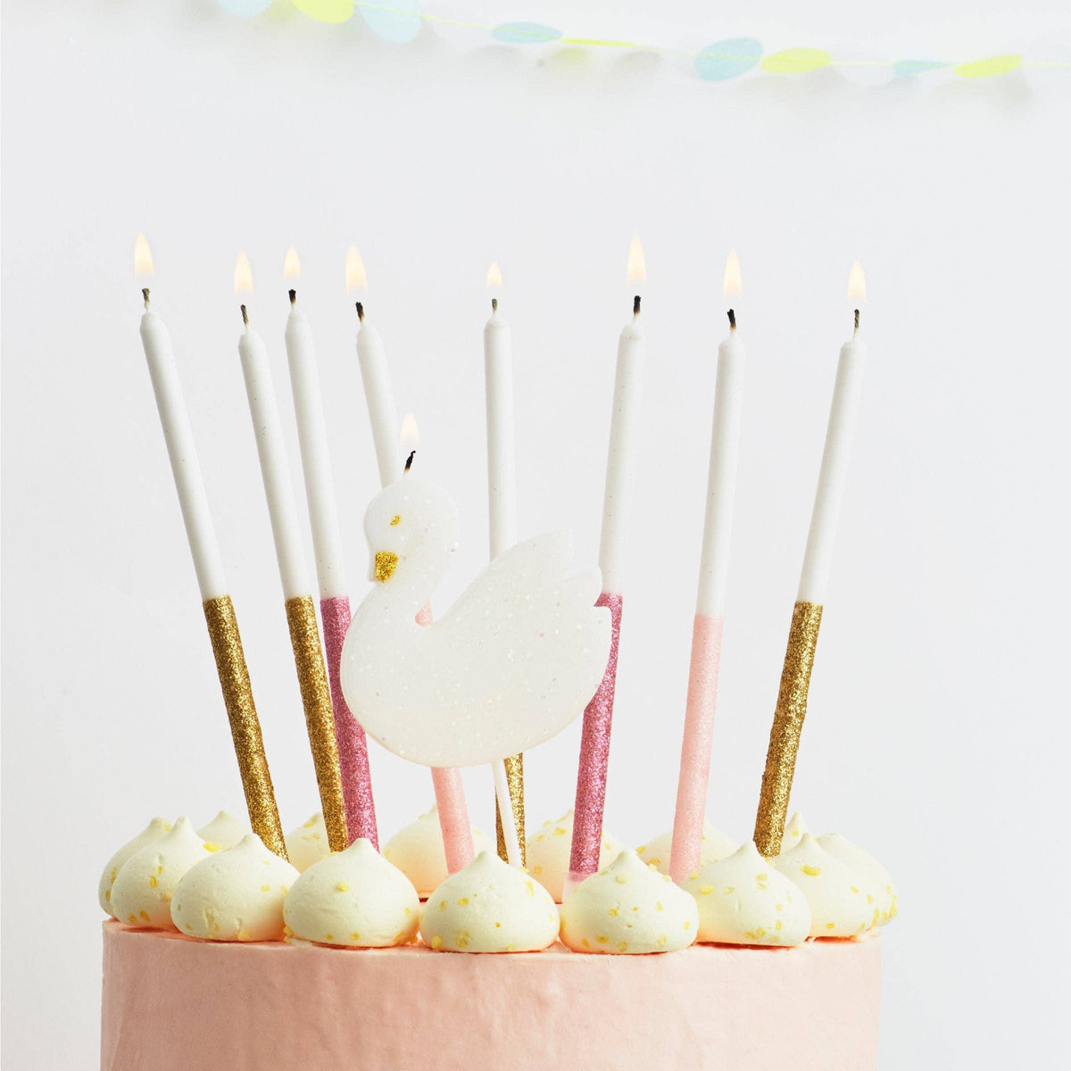 Decorative candles on a cake with a white background