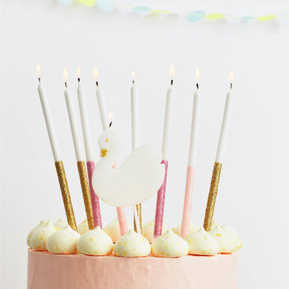 Decorative candles on a cake with a white background