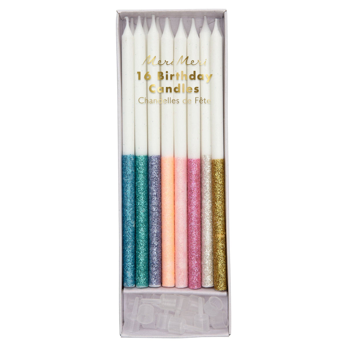 Set of colorful glitter dipped birthday candles in a box on a white background