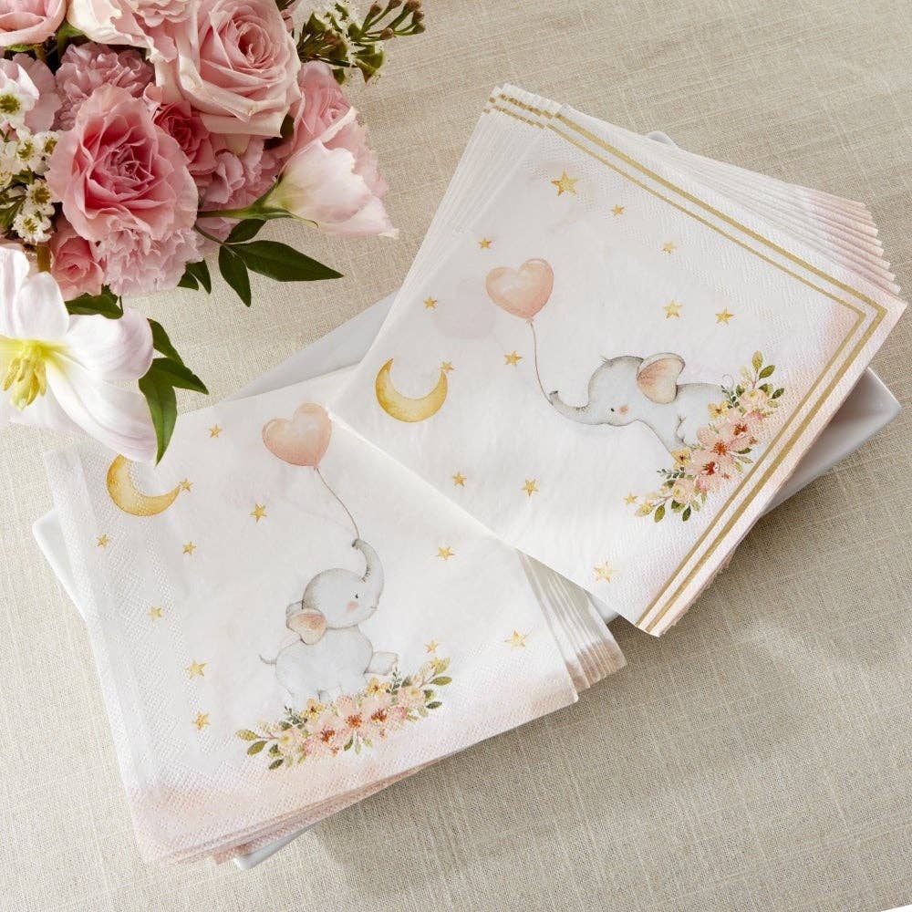 Pink and white napkins with a baby elephant and pink heart balloon design on a table with flowers.