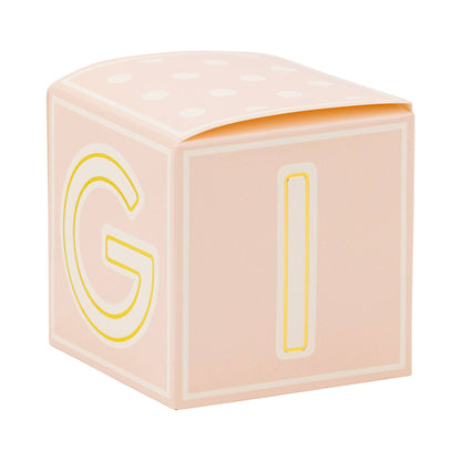 Pink baby block with yellow letters 'G' and 'I' on a white background
