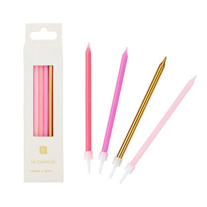 Set of pink and gold candles with packaging on a white background