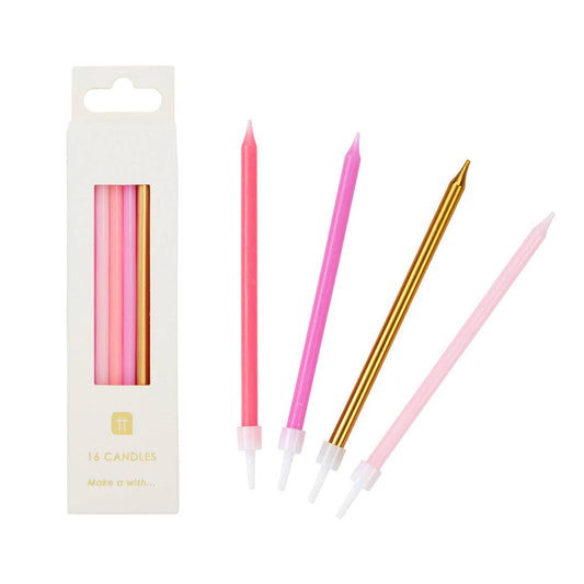 Set of pink and gold candles with packaging on a white background