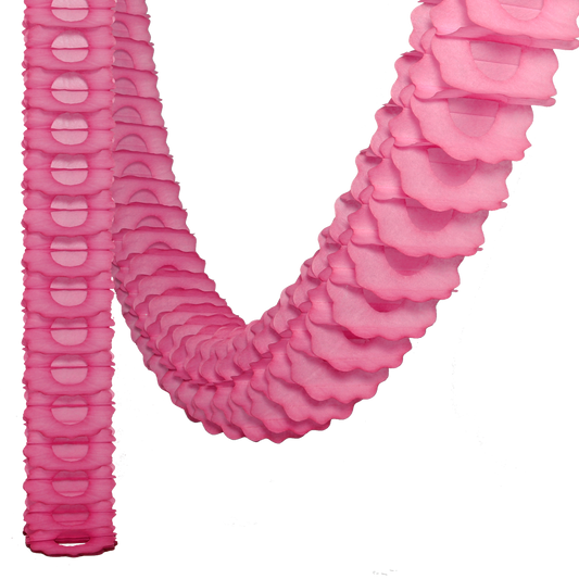 A pink paper garland with intricate scalloped design, coiled and laid out on a white background.