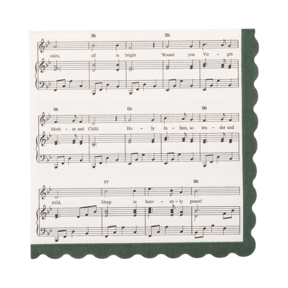 A square beverage napkin designed with sheet music print of "Silent Night" with a scalloped dark green border, featuring musical notation and the text 'Round you Virgin, Mother and Child." 