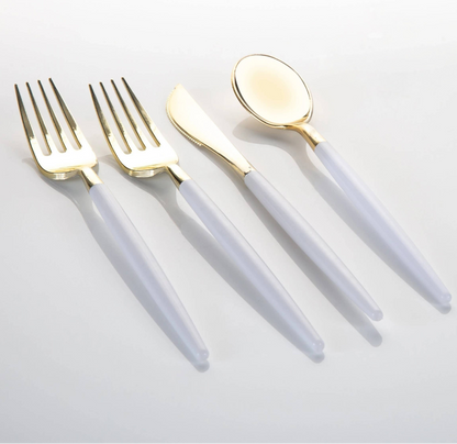 A 4-piece flatware set with gold-tone metal heads and translucent white handles, arranged diagonally on a light gray background.
