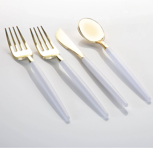 A 4-piece flatware set with gold-tone metal heads and translucent white handles, arranged diagonally on a light gray background.