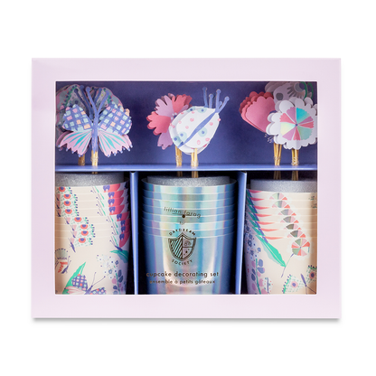 A set of butterfly-themed cupcake toppers and baking cups with pastel colors and holographic silver foil accents, displayed in packaging.