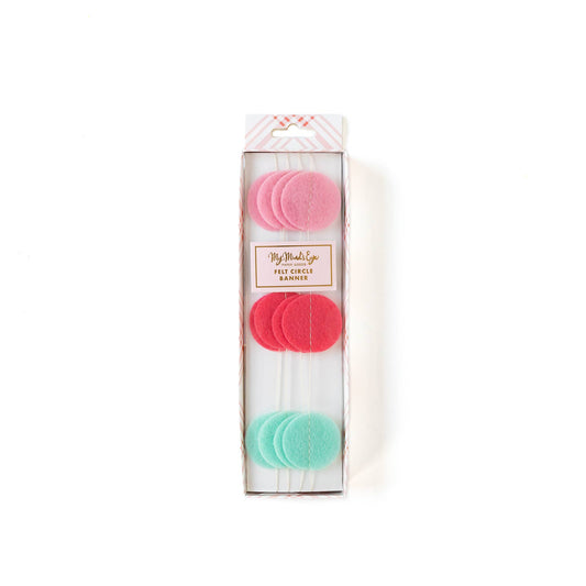 Packaged felt circle banner in shades of mint green, dark pink, and light pink, displayed in a clear plastic box with a white background.