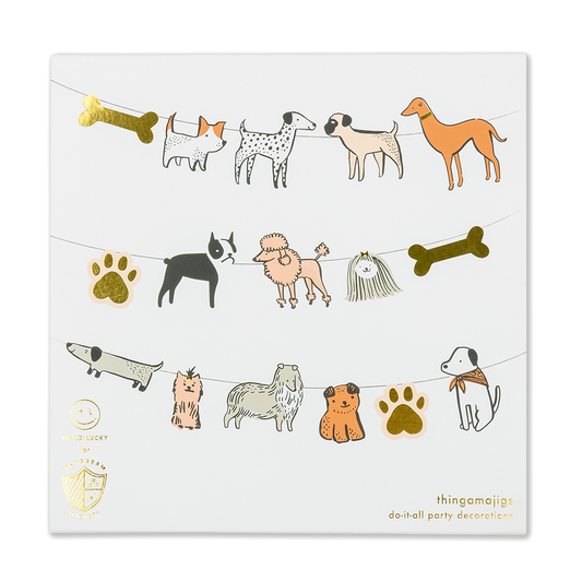 A party banner with die-cut shapes of dogs, bones, and paws connected by a string, with gold foil accents.