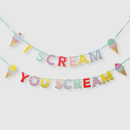 A colorful party banner with the text 'I Scream, You Scream' arranged in a playful font, featuring ice cream cone designs and metallic gold accents.