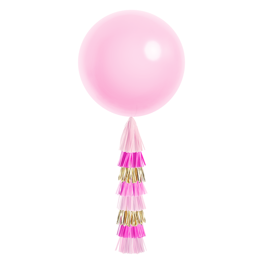 A large pink balloon with a tassel tail made of light pink, hot pink, and gold tissue paper tassels.