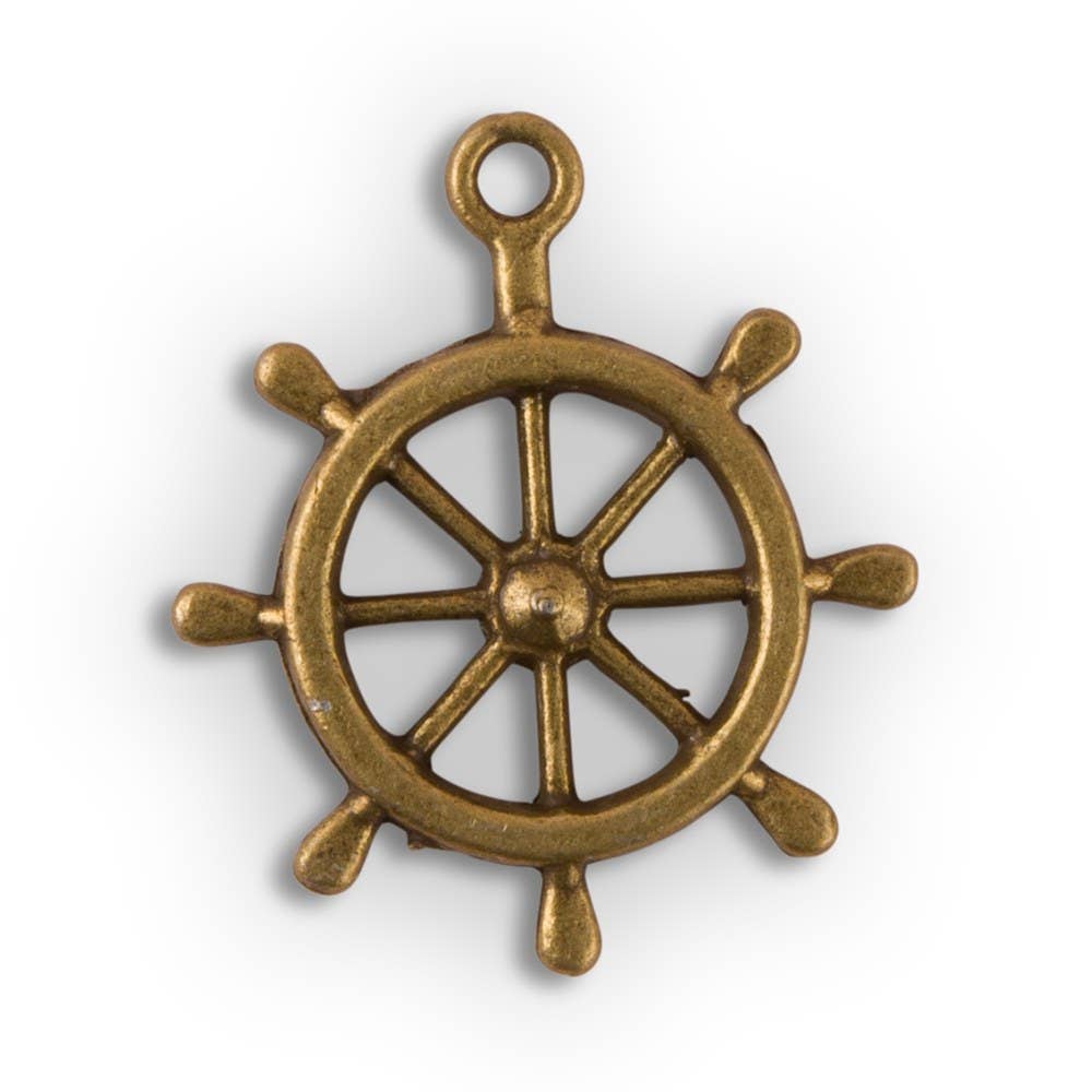 A gold-colored metal boat wheel charm with a antique brass finish.
