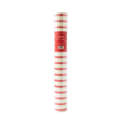 A rolled up red and white striped paper table runner with product label visible.