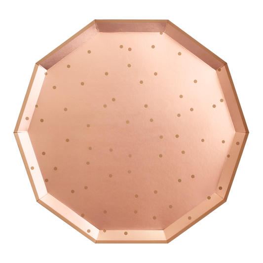 A rose gold paper plate with confetti pattern.
