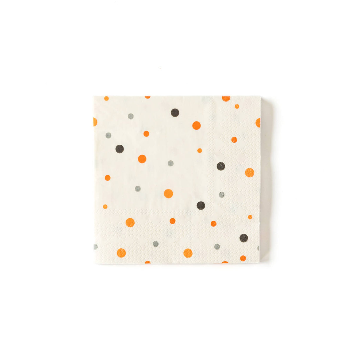 A square cocktail napkin with orange and black polka dots on a white background.
